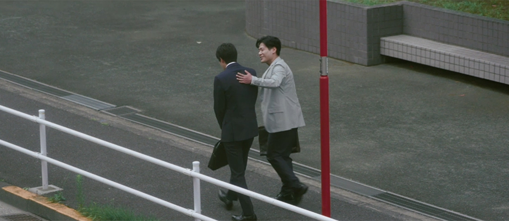 営業担当と上司が歩きながら話す場面
